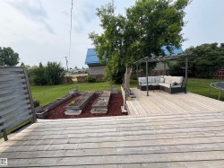 Spacious wood deck and raised gardens. - 