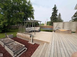 Expansive wooden deck featuring multiple levels and a built-in privacy screen - 