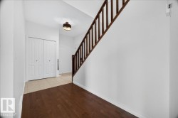 Entryway featuring wood-finish flooring, a bi-fold closet, and a contemporary ceiling fixture - 