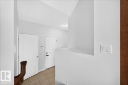 Entryway featuring neutral wall colors, recessed lighting, and tile flooring - 
