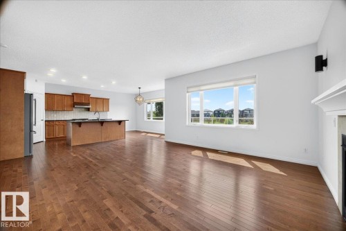 Expansive open-concept living space featuring wood-finish flooring - 8508 218 Street, Edmonton, AB 