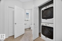 Dedicated laundry closet with stacked appliances - 
