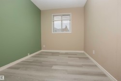 Room featuring light wood-finish flooring, a window with horizontal blinds, and a textured ceiling - 