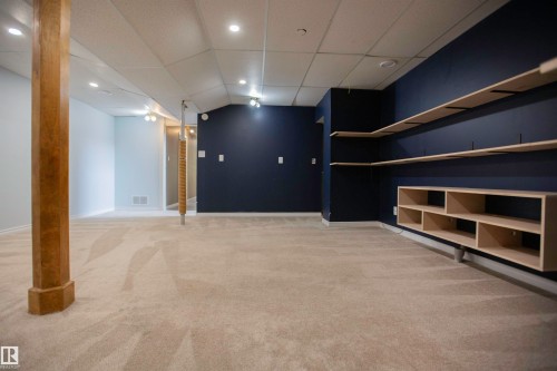 Carpeted room featuring a drop ceiling with recessed lighting - 3531 46 Street, Edmonton, AB 