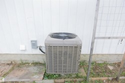 Exterior mechanical unit positioned on a concrete pad - 
