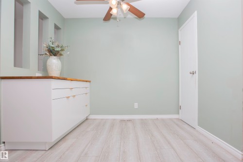 Light wood-finish flooring complements the neutral wall color - 3531 46 Street, Edmonton, AB 