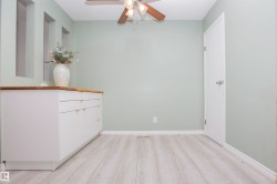 Light wood-finish flooring complements the neutral wall color - 
