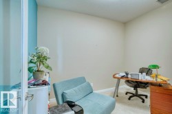 Carpeted room with a textured ceiling, a light-colored wall, and a light blue accent wall - 