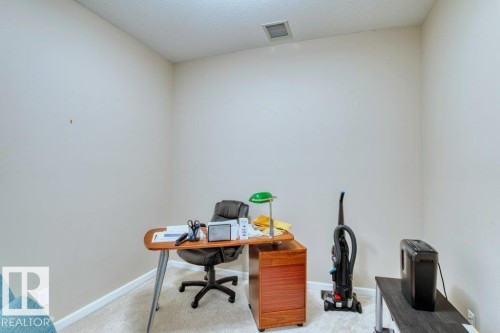 Carpeted room with neutral wall paint and white trim - 319 6083 Maynard Way, Edmonton, AB 