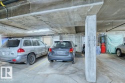 Underground parking space with designated concrete pillar and fluorescent lighting - 