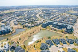 Aerial perspective showcasing a residential development with multiple detached homes and multi-story apartment buildings - 