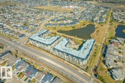 Aerial perspective showcasing a residential development with two prominent L-shaped buildings - 