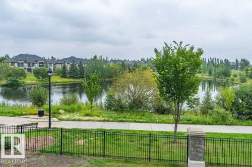 Waterfront property with established landscaping and a paved path - 319 6083 Maynard Way, Edmonton, AB 