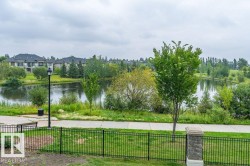 Waterfront property with established landscaping and a paved path - 