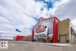 Contemporary commercial building featuring a prominent glass and red facade - 
