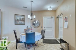 Entry area featuring a white paneled door, a mirrored closet with sliding doors, and a tiled floor - 