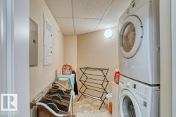 Dedicated laundry area featuring stacked appliances and tiled flooring - 