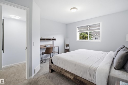 Carpeted room featuring a double-paned window with roller shades, a flush-mount ceiling light, and light-colored walls - 92 230 Edwards Drive, Edmonton, AB 