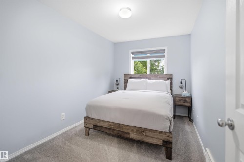 Carpeted room featuring light blue walls and a window with blinds - 92 230 Edwards Drive, Edmonton, AB 