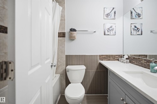 Bathroom featuring a single vanity with a white countertop, under-mount sink, and gray cabinetry - 92 230 Edwards Drive, Edmonton, AB 