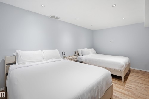 Room featuring light wood-finish flooring, recessed ceiling lighting, and light blue wall paint - 92 230 Edwards Drive, Edmonton, AB 