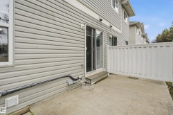 Concrete patio featuring a privacy fence and sliding glass door access - 