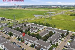 Aerial perspective showcasing a residential community with multiple townhouse buildings - 
