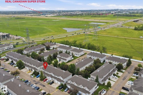 Aerial perspective showcasing a residential community with multiple townhouse buildings - 92 230 Edwards Drive, Edmonton, AB 