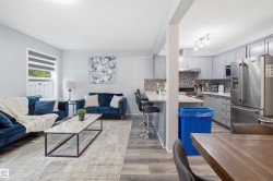 Open-concept living space featuring wood-finish flooring - 