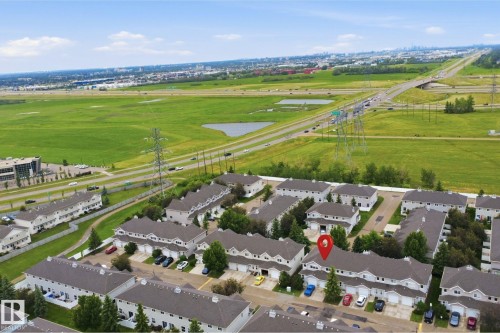 Aerial perspective showcasing a residential community with townhomes and detached garages - 92 230 Edwards Drive, Edmonton, AB 