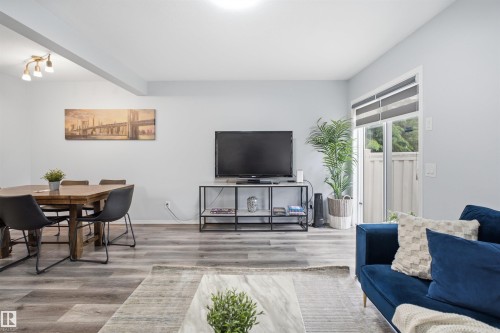 Open-concept living space with wood-finish flooring - 92 230 Edwards Drive, Edmonton, AB 
