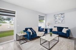 Living area featuring light gray walls, wood-finish flooring, a sliding glass door, and a window with horizontal blinds - 