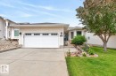 Cream-colored siding exterior with an attached two-car garage - 448 Ormsby Road W, Edmonton, AB 