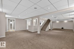 Expansive lower-level space featuring broadloom carpet, recessed lighting, and a drop ceiling - 