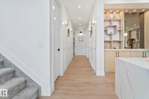 Hallway featuring wood-finish flooring, recessed lighting, and wall paneling - 13152 187 Avenue, Edmonton, AB 