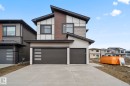 Modern architectural exterior featuring multiple material finishes, an asymmetrical roofline, and integrated two-car garages - 13152 187 Avenue, Edmonton, AB 