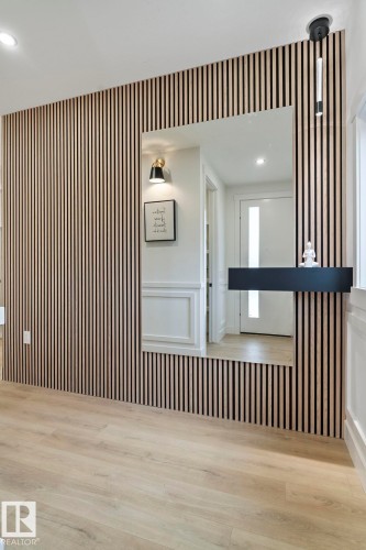 Vertical wood slat accent wall with an integrated rectangular mirror - 13152 187 Avenue, Edmonton, AB 