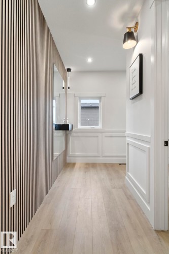 Entryway featuring a decorative slat wall accent and light wood-finish flooring - 13152 187 Avenue, Edmonton, AB 