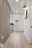 Entryway featuring a decorative slat wall accent and light wood-finish flooring - 13152 187 Avenue, Edmonton, AB 