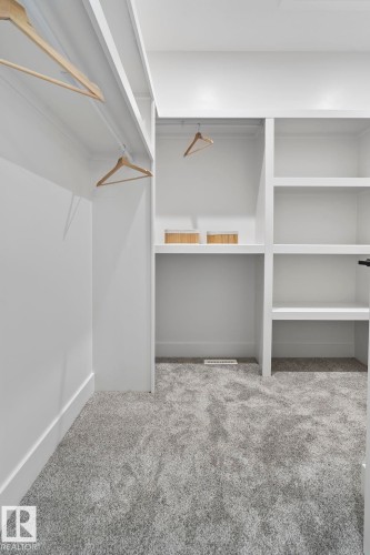 Custom closet system featuring multiple hanging rods and integrated shelving - 13152 187 Avenue, Edmonton, AB 