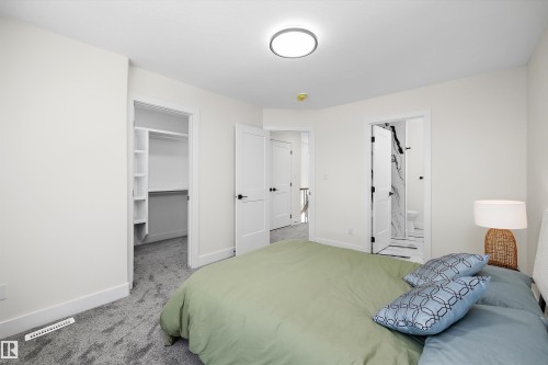 Bedroom with plush gray carpeting, white walls, and a contemporary flush-mount ceiling light - 8319 81 Avenue Nw, Edmonton, AB 