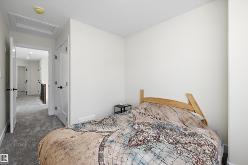 Bright bedroom with clean white walls and a light-toned wood headboard - 8319 81 Avenue Nw, Edmonton, AB 