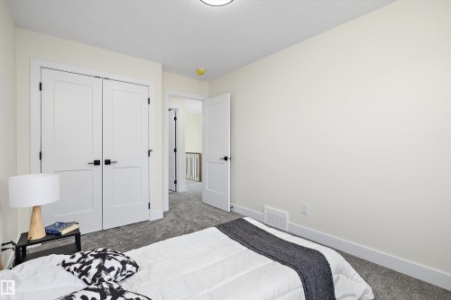 Bedroom featuring light-toned walls, grey carpet flooring, and white trim - 8319 81 Avenue Nw, Edmonton, AB 