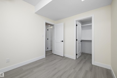 Bedroom 1 in legal suite with walk in closet. - 8319 81 Avenue Nw, Edmonton, AB 