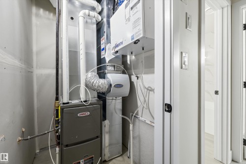 Dedicated utility closet featuring a Lennox furnace, a humidifier, and a Lifebreath air exchanger - 8319 81 Avenue Nw, Edmonton, AB 