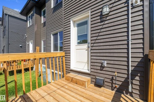 Wood-finish deck with wooden railings, providing outdoor access from the property - 8319 81 Avenue Nw, Edmonton, AB 