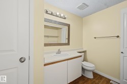 Bathroom vanity featuring a white countertop with an integrated sink, a large framed mirror, and a five-light fixture - 