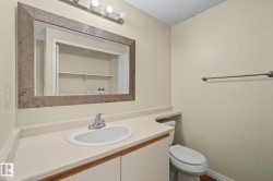 Bathroom vanity featuring a light-colored countertop, integrated sink, and chrome faucet - 