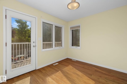 Room featuring wood-finish flooring, light-toned walls, and a ceiling-mounted light fixture - 4259 29 Avenue, Edmonton, AB 