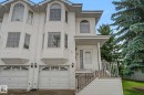 White siding exterior with multiple bay windows and arched window details - 4259 29 Avenue, Edmonton, AB 